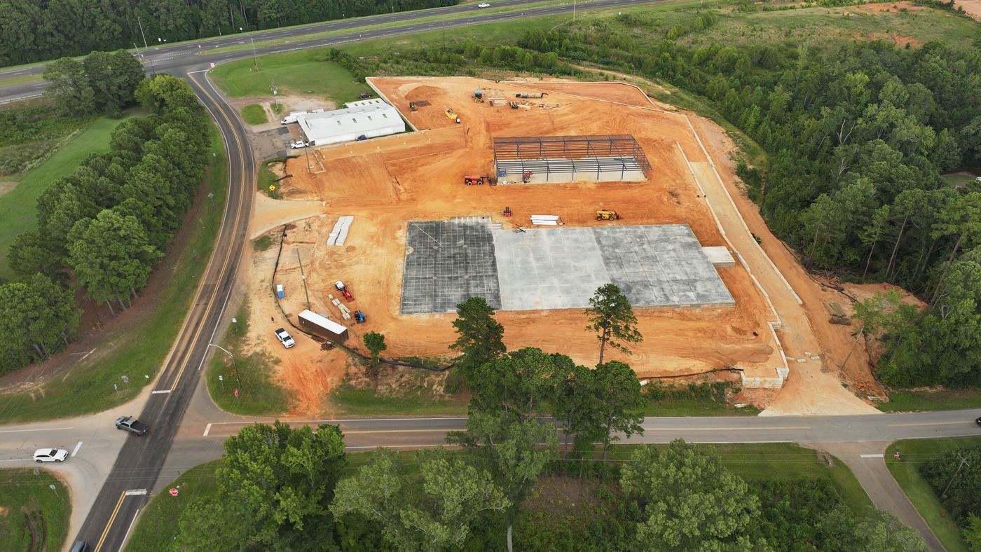 Aerial of an industrial site with slabs poured and steel going up